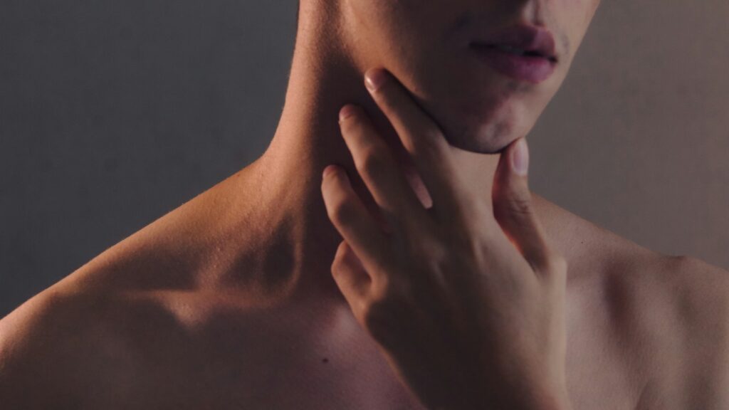 Hand resting on the jawline, illustrating jaw clenching and masseter tension